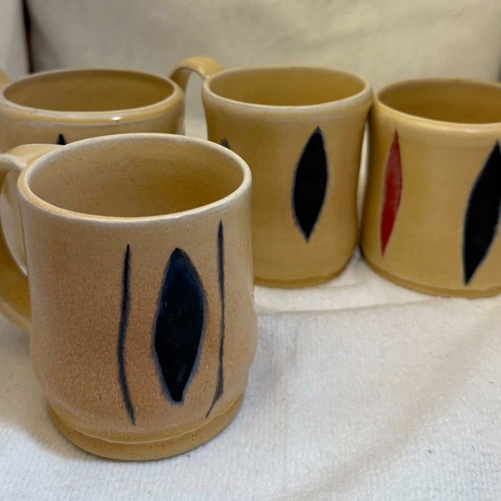 4/ studio art mugs. Tan with Black and Red Accents